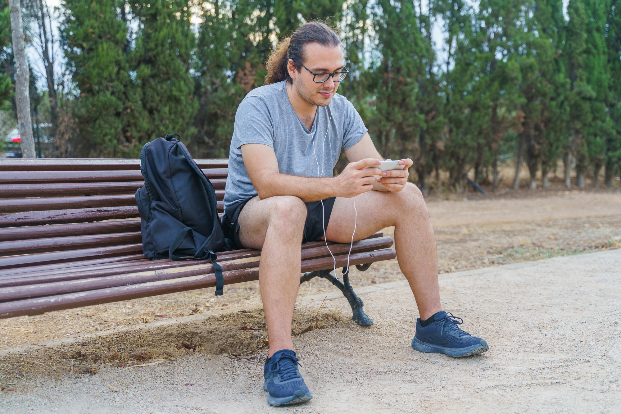 Man playing on his smartphone in the park