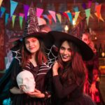 Portrait of excited young witches for halloween party